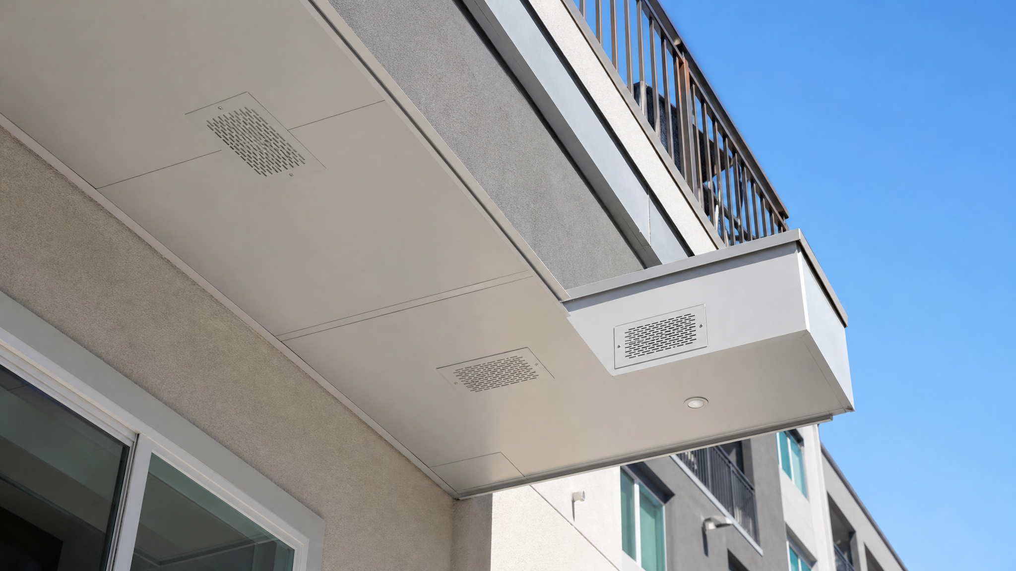 Fire-rated soffit vents under a multifamily balcony in Los Angeles.