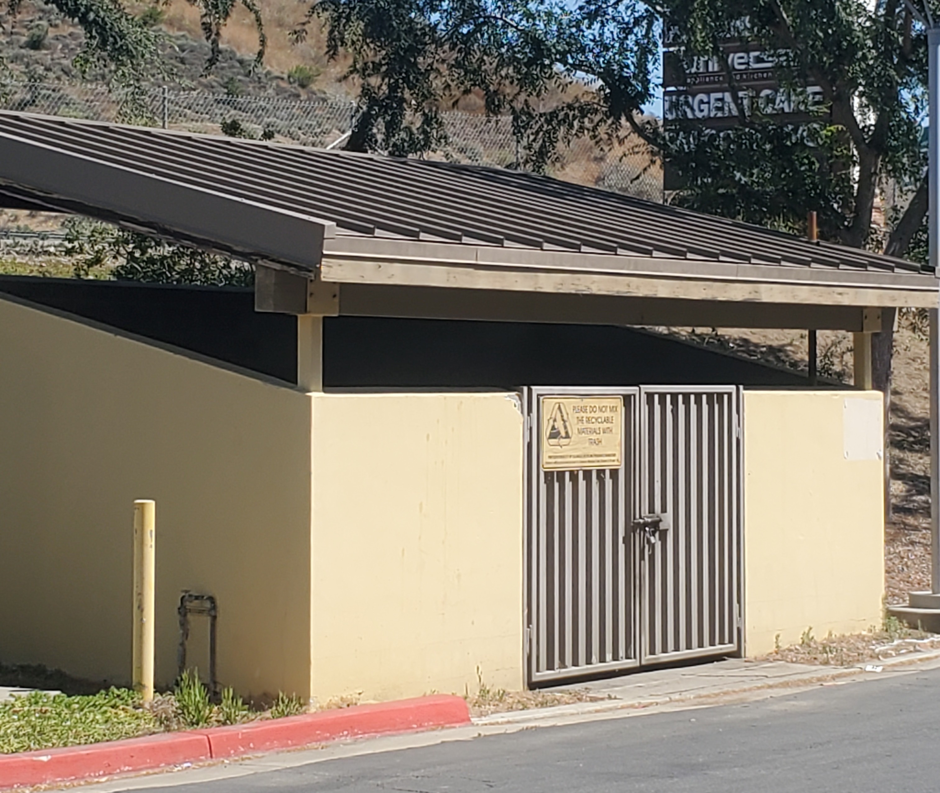 Brown standing seam metal roof on a commercial trash and recycling enclosure in Agoura Hills