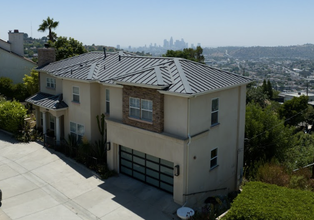 Charcoal grey standing seam metal roof on a two-story home overlooking the Los Angeles skyline