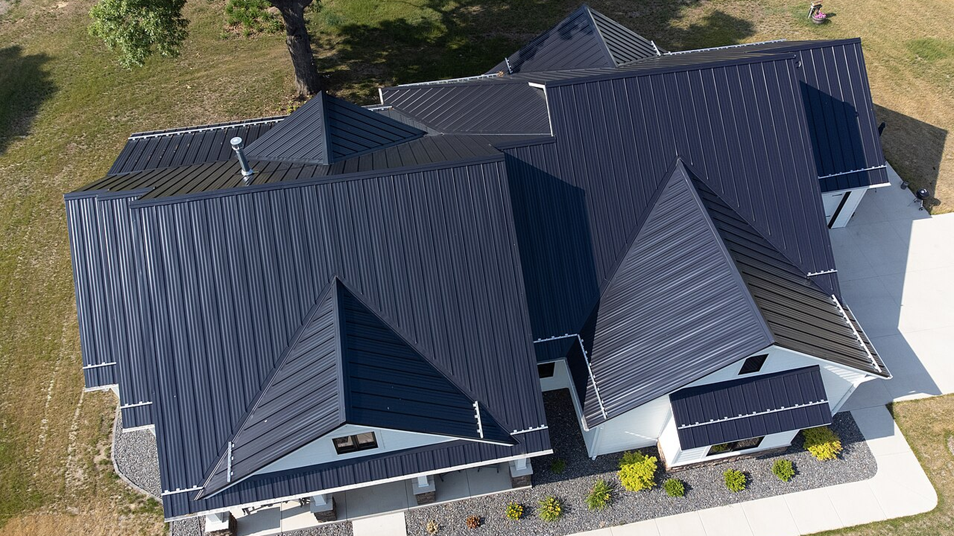 Architectural standing seam system on contemporary custom home with mixed materials