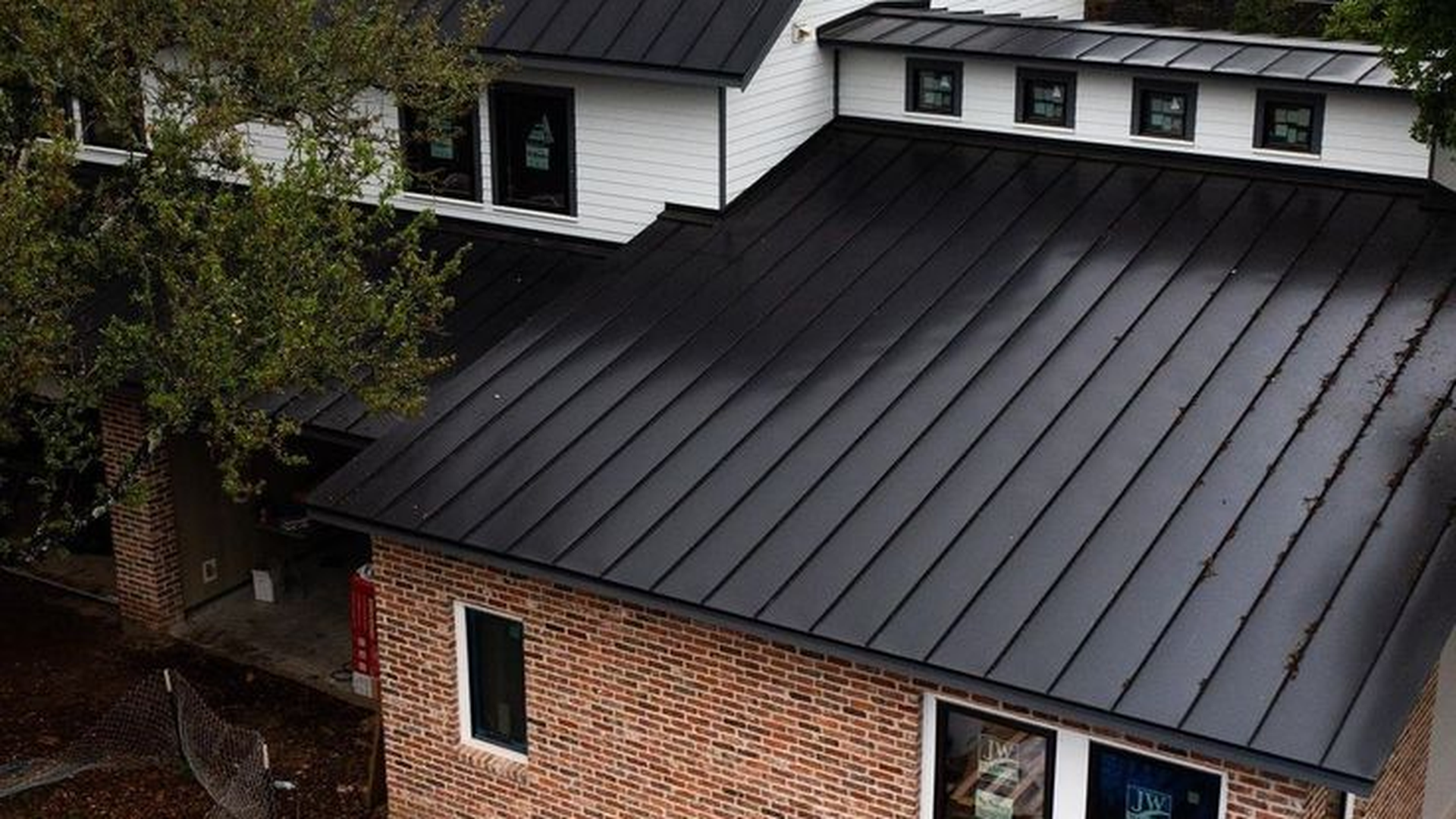 Modern contemporary home with matte black standing seam metal roof in Southern California