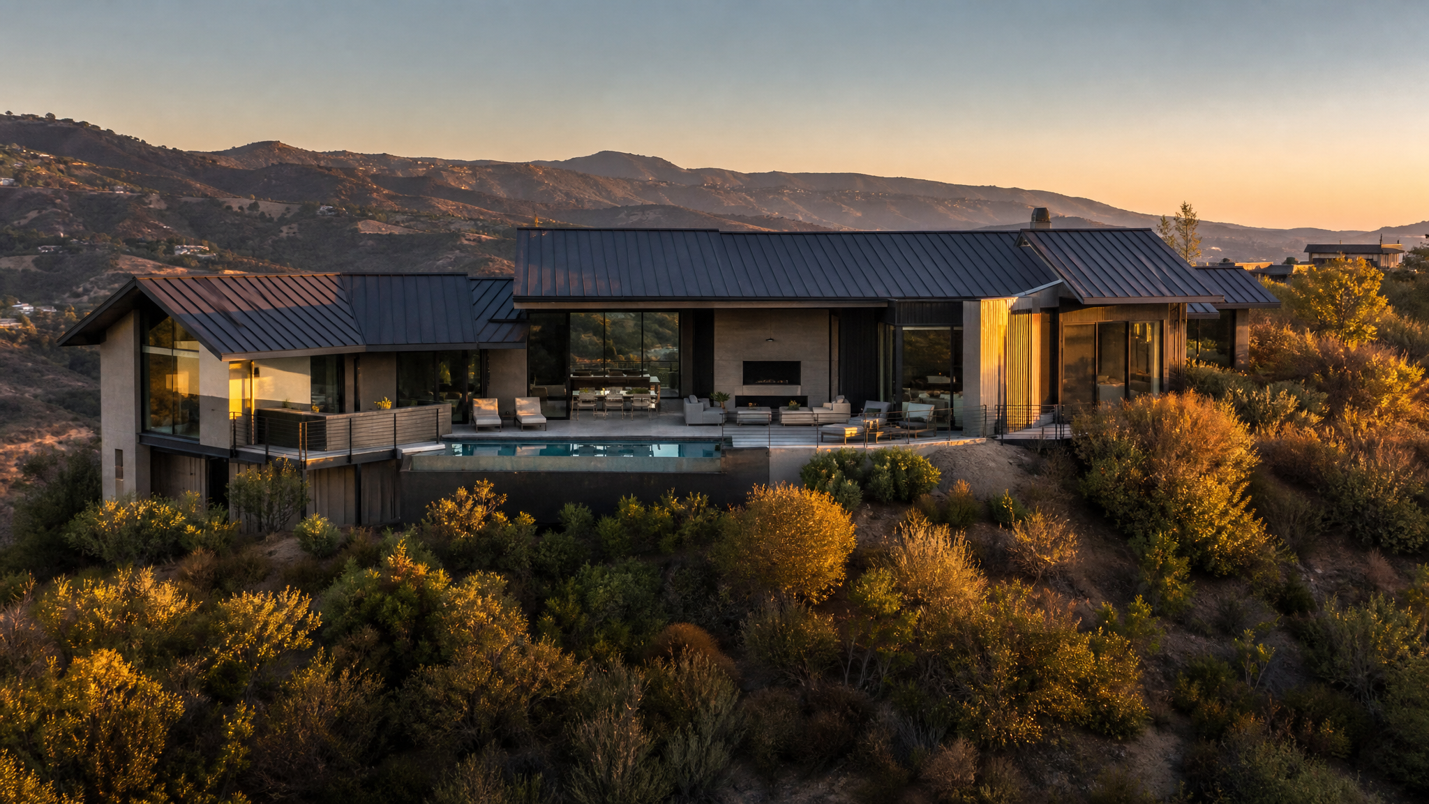 Luxury hillside residence featuring standing seam metal roof in wildfire-prone Southern California environment