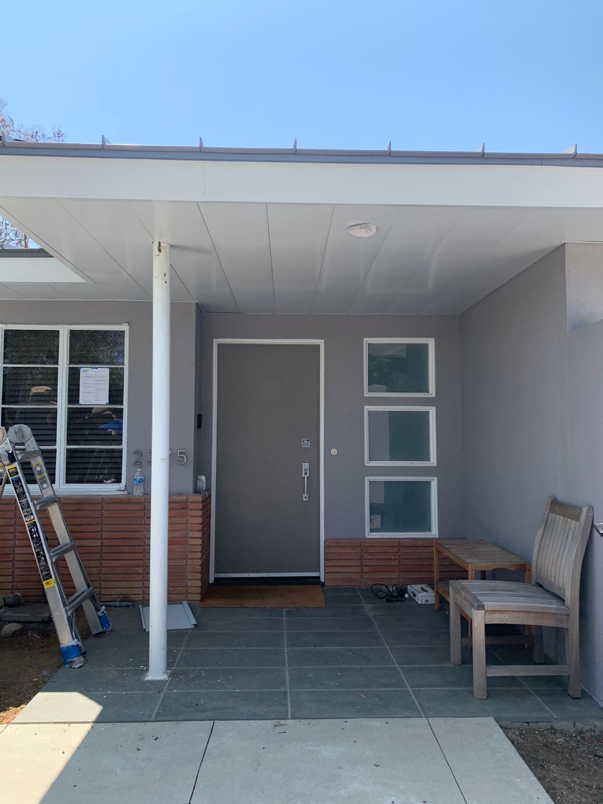 Metal-enclosed eaves and ember-resistant soffit protection on a standing seam roof.